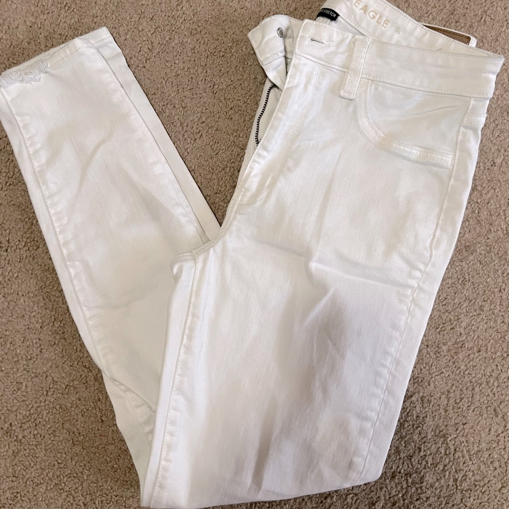 White skinny jeans. Holes in knees. American eagle.